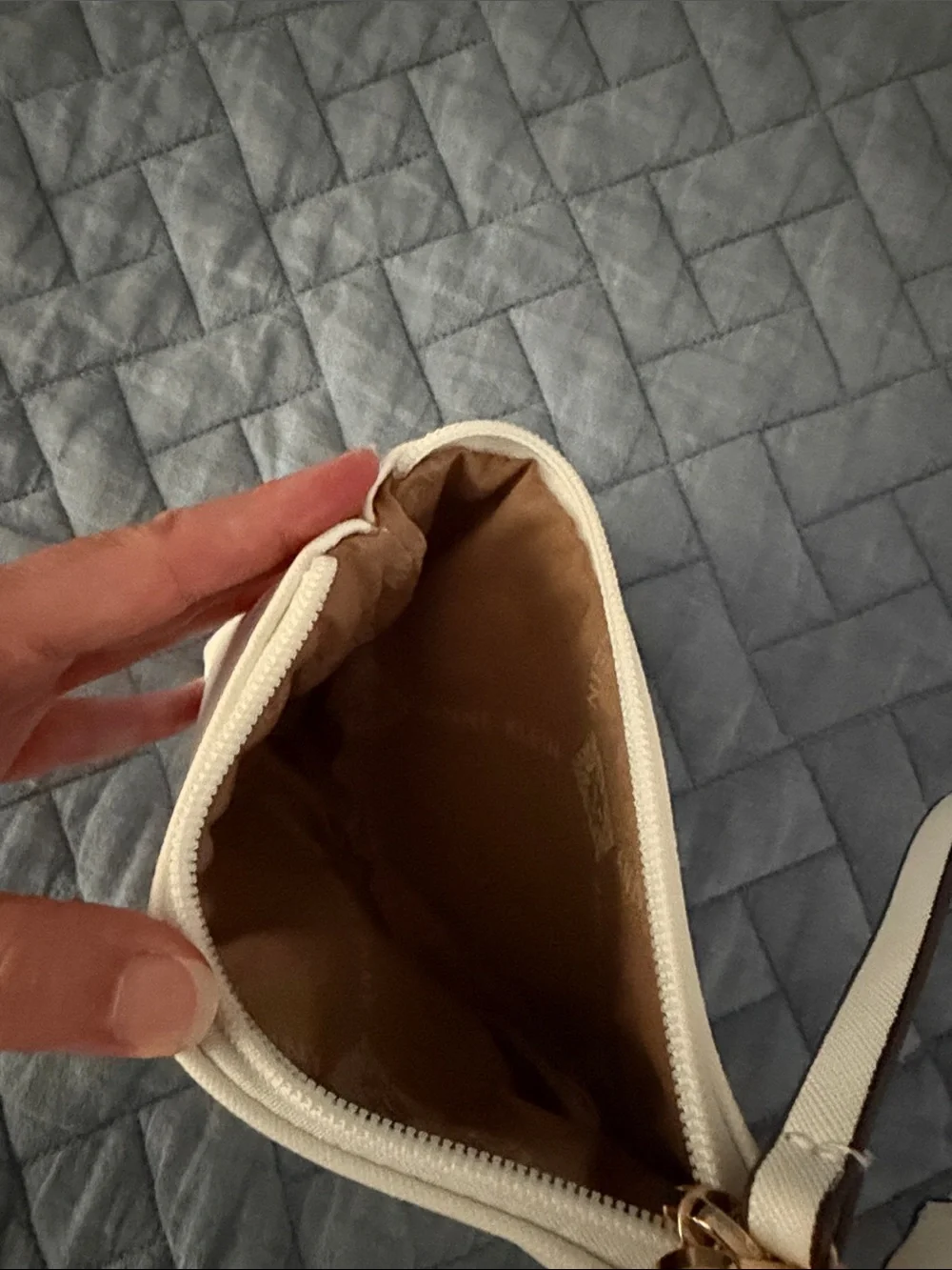 Cream Wristlet Clutch with Gold Emblem